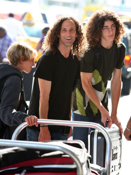 Max Gorelick in a black t-shirt with his dad Kenny G.